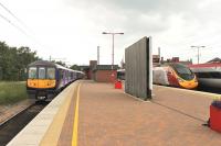 319380, in new <I>Northern Electrics</I> livery, makes a connection with two Pendolinos at Wigan North Western on 25 June, prior to returning to Liverpool Lime Street via St Helens. Although these 4-car former <I>Thameslink</I> EMUs have been around for some time they have been refurbished and are a great improvement on the 2-car Pacers they have replaced on these services. <br><br>[Mark Bartlett 25/06/2015]