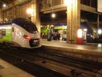 Two generations of SNCF TER EMUs, operating services to the Picardie Region, stand at Gare du Nord during the early evening on 24 February 2015. Nearest the camera is new Alstom Regiolis 6 car single deck unit 84519L, whilst across platform is older Alstom built double deck unit 446.<br><br>[David Pesterfield 24/02/2015]