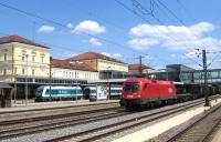 A typical scene at Regensburg in south east Bavaria on 17th June, with an international freight train - in this case hauled by an Austrian Railways (OBB) Taurus electric loco - hurrying through the centre roads at the Hauptbahnhof, while in the background a Class 223 diesel of the 'Alex' company has just been released from the stock of its Munich-Regensburg train. Alex also run the Munich-Prague trains, one of many franchised services which DB has lost to private operators in this part of Germany in recent years [with thanks to Bill Jamieson].<br><br>[David Spaven 17/06/2015]