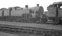 Locomotives in the shed yard at Llanelli (87F) on 7 August 1960 include Fowler 2-6-4T 42387 of Landore stabled behind home based Collett 0-6-2T 5656.<br><br>[K A Gray //]