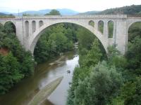 The impressive 1885 Pont ferroviaire de Ceret viaduct, across the Le Tech river at the eastern side of Ceret, on the remaining section of the branch line that originally ran from Elne to Arles-sur-Tech; but no longer exists beyond the former Ceret station sited some 700 metres to the left. Most of the final section between St-Jean-Pla-de-Corts yard and Ceret station is now mothballed and overgrown.  <br><br>[David Pesterfield 01/08/2015]
