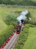 A train on the miniature Beer Heights railway emerges from the tunnel on its way back to the main station. Trains pass through the long tunnel twice while making a scenic circuit of the line and on the far side emerge onto a headland with panoramic views. <br><br>[Mark Bartlett 01/08/2015]