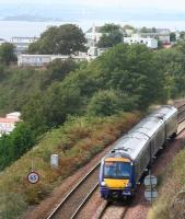 A Fife Circle train skirting Pettycur Bay on 8 September 2008 is about to enter Kinghorn Tunnel. The 'scaffolding and bandages' on the Forth Bridge can be made out in the left background, despite the sea mist hanging over the Forth on this particular morning.<br><br>[John Furnevel 08/09/2008]