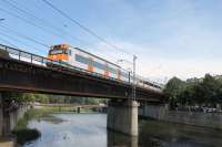 A RENFE Class 447 EMU heads south from Girona and crosses the River Onyar with a stopping train for Barcelona. This bridge is just by the Basilica church on the edge of the old town area of the city. <br><br>[Mark Bartlett 17/09/2015]