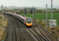 Euston bound 390121 speeds past the Eden Goods Loop at Clifton and Lowther on 23rd October 2015. The tracks are widening at this point because they pass under a twin arch bridge. (Grid Reference NY541257)<br><br>[Mark Bartlett 23/10/2015]