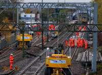During the first day of the engineering possession, a contractor's engineering team works on the first half of the new facing crossover which has been installed on the down line just past the end of the Anniesland eastbound platform.<br><br>[Colin McDonald 07/11/2015]