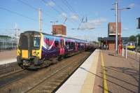 A TransPennine service from Scotland calls at Wigan North Western on 15 July 2015 en route to Manchester Airport. On the right a Northern Electrics stopping service to Liverpool Lime Street awaits its scheduled departure time.<br><br>[John McIntyre 15/07/2015]