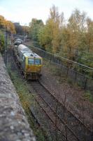 The railhead treatment unit returning to Mossend  shortly afte rSunnyside Junction on the Whifflet Loop on the 30th of October. Barely visable through the trees is the 311 unit (311 103) stored at Summerlee Heritage Park.<br><br>[Alastair McLellan 30/10/2015]