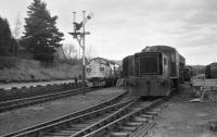 BR Class 37 no 37114 prepares to depart from Boat of Garten back to Aviemore light engine after having brought in the 'Royal Scotsman' in April 1986. On the right is an NBL 0-4-0 DH shunter stabled in front of ex LMS Black 5 no 5025.<br><br>[John McIntyre 27/04/1986]