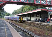 A FGW 150/153 combination slows for the stop at Torre heading for Torquay and Paignton on 26th July 2015. Although the station canopy still shelters the Down platform the station building itself is in commercial use, accessed from the forecourt.<br><br>[Mark Bartlett 26/07/2015]