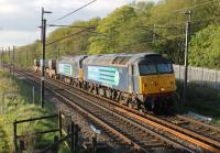 Two DRS Class 57s take the evening flask train south along the WCML in May 2015. 57012 and 57002 have just passed Scorton and are approaching the footbridge at Broad Fall Farm.  <br><br>[Mark Bartlett 13/05/2015]