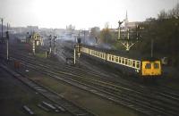 Daylight is waning and a damp chill is in the air around Norwich station on 13th November 1976. A 'Swindon' DMU set, coupled to a 'MetCam' set, makes a noisy and smoky departure from the terminus heading for Ely and Cambridge.<br><br>[Mark Dufton 13/11/1976]