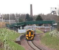 158728 runs south between the two new footbridges at Newtongrange on 29 February 2016 and is about to pass through the site of the 1908 station. The train is the ScotRail 1054 Edinburgh - Tweedbank.<br><br>[John Furnevel 29/02/2016]