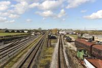 A general view of the preservation site at the Buckinghamshire Railway Centre at Quainton Rd. The preservation group occupies land on both sides of the surviving BR freight line from Aylesbury, seen here running through the middle. The two parts are linked by footbridges and some of the preserved stock and the old Rewley Road station building can be seen in this view. <br><br>[Peter Todd 24/02/2016]