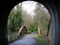 On leaving the west portal of Auchendinny tunnel, trains on the Penicuik Railway crossed a bowstring girder bridge over the North Esk before reaching the station. The surviving platform stands on the left immediately beyond the bridge in this view from the tunnel on a bright but chilly morning in March 2016. The route now forms part of a walkway.  <br><br>[John Furnevel 28/03/2016]