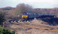 66100 hauls a train of hot rolled coil up Stormy Bank heading for Llanwern. Behind the was Water Street Junction, controlled by Pyle West signal box, which led to the reception sidings for Margam Marshalling Yard, which were off to the left.<br><br>[Alastair McLellan 07/01/2010]