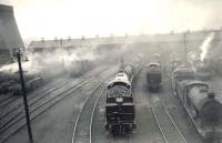 General view of the north end of Eastfield shed on 29 April 1950 with a smokescreen hanging over the busy yard. Photograph taken from the window of a passing train on the Balornock Junction to Possil line. <br><br>[G H Robin collection by courtesy of the Mitchell Library, Glasgow 29/04/1950]