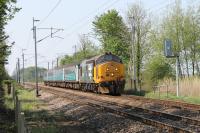 37401 <I>Mary Queen of Scots</I>, approaches the level crossing at Bolton-le-Sands with the 1004hrs Preston to Barrow service. During 2016 37401, 402, 409, 423 and 425 have all seen use on Cumbrian Coast services, the first two running in <I>Large Logo</I> livery.  <br><br>[Mark Bartlett 12/05/2016]