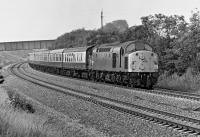 When Healey Mills based EE Type 4 No. 40 048 passed me at 10:23 on the morning of Saturday 2 August 1975 near Oakenshaw North Junction with a rake of Mk 1 coaches in tow, I assumed that this was an excursion to the Yorkshire coast. However, after perusing the 1975 BR timetable recently in the NLS, I have now concluded that the train is actually the dated 09:42 SO Sheffield to Glasgow, the successor to the 06:40 SO Birmingham to Glasgow, a train of some renown in 1966/67 because of its 'Jubilee' haulage over the S&C. In 1975 the class 40 no doubt gave way to a Holbeck based class 45 at Leeds.<br><br>[Bill Jamieson 02/08/1975]