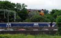 With the tree growth, this is definitely the wrong time of year for this photograph. The service from Helensburgh Central arrives and is held back for some time while the empties from Fort William drop down through the closed Craigendoran Upper and then a Sprinter heads north.<br><br>[Ewan Crawford 13/06/2016]