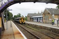 158710, on a service from Inverness to Ardgay, draws to a stand alongside the station building at Tain, now converted into the recently opened and excellent <I>Platform 1864</I> restaurant that has won Railway Heritage awards for the tasteful building conversion.<br><br>[Mark Bartlett 22/07/2016]