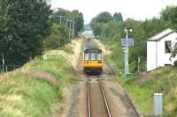A Preston to Ormskirk service crosses Pages LC as it approaches the camera on 09 August 2016. In the background a car crosses at Midge Hall LC and the semaphore signal protecting it can just be made out to the left of the rear of the train.<br><br>[John McIntyre 09/08/2016]