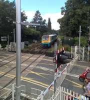 A midday Sunday service to Manchester Piccadilly passes the full paraphernalia of a modern level crossing as it slows for Nantwich station on 7 August 2016.<br><br>[Ken Strachan 07/08/2016]