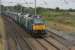 Two nearly new DRS Class 68s, 68020 <I>Reliance</I> and 68018 <I>Vigilant,</I> take the <I>Tesco Express</I> north through Hest Bank on a gloomy 20th August 2016. <br><br>[Mark Bartlett 20/08/2016]
