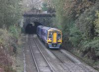 Northern 158797, on a Manchester Victoria to Leeds service, leaves Winterbutlee Tunnel and continues towards the (new) Walsden station on 31st October 2016. Inside the 300yd tunnel, the tail lamp and silhouette of a westbound loaded coal train can be seen as it climbs towards the Summit Tunnel. The train is passing the site of the original station, closed in 1961.<br><br>[Mark Bartlett 31/10/2016]