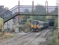 Leyland Sprinter 155343 pulls away from a stop at Walsden (new) station heading towards Manchester on 31st October 2016. The original Walsden station, closed in 1961, lay between the footbridge and Winterbutlee Tunnel with a level crossing in the foreground. <br><br>[Mark Bartlett 31/10/2016]