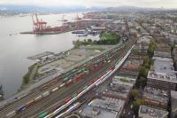 An aerial view of the freight yard adjacent to Vancouver’s Waterfont Station and container terminal shows a train of containers being marshalled.  When the operation is complete the sidings will be empty and the locomotives at the head of the train will be some two miles distant ready to start their eastward journey.  Also visible in the sidings are four rakes of coaching stock for the evening’s West Coast Express trains to Mission<br><br>[Malcolm Chattwood 04/10/2016]