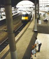 The arrival at Newcastle of a GNER service from the south fails to interrupt ballet practice in progress alongside platform 2. View west from the station footbridge in April 1997. <br><br>[John Furnevel 05/04/1997]