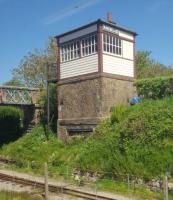 Two gauges at Ravenglass: the narrow gauge viewed from a train on the standard gauge railway. The signal box, although in good condition, no longer controls trains.<br><br>[John Yellowlees 08/04/2017]