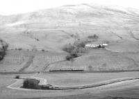 An unidentified 3-car DMU passing Corsencon Farm south of New Cumnock. View north over the River Nith from a viewpoint alongside the A76. Thought to have been taken in September 1980.<br><br>[John Furnevel 27/09/1980]