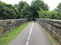 View north along Viaduct Walk at the Kinness Burn viaduct [see image 35756] in June 2017. The walkway and cycle route are at formation level along the trackbed of the former Anstruther and St Andrews Railway. Further north at the end of the walkway, the trackbed has been infilled to bring it up to street level for use as a series of car parks.<br><br>[Colin McDonald 15/06/2017]