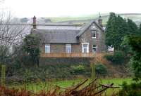 The surviving main building of the former station at Tarff on the Kirkcudbright branch in November 2005, more than 40 years after closure of the line. View is east across the A75 road.<br><br>[John Furnevel 09/11/2005]