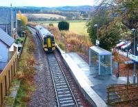 A Kyle of Lochalsh - Inverness train leaving Beauly in 2003, showing part of the original station building on the left.<br><br>[John Furnevel 23/11/2003]