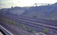 A view of the roughcastle opencast loading pad, near Falkirk, seen from a passing eastbound train in June 1989. In 2011 this remains in place, but overgrown.<br><br>[Ewan Crawford 12/06/1989]