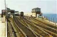 Stranraer Harbour in the 1980s. Rolling stock for a train to London rests in the station.<br><br>[Ewan Crawford //]