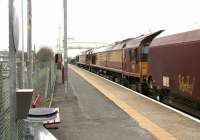 A train of loaded coal hoppers southbound through Auchinleck station on a chilly 13 March 2006. The train is double headed by a pair of EWS class 66 locomotives, with 66177 nearest the camera.<br><br>[John Furnevel 13/03/2006]