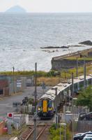 380111 crosses Princes Street to enter Ardrossan Town with a Glasgow bound train. Ailsa Craig is on the horizon.<br><br>[Ewan Crawford 10/08/2017]