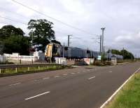 A Dunbar service crosses St Germains level Crossing in the East Lothian countryside on 16th August 2017. The ScotRail services from Waverley to Dunbar call only at Musselburgh leaving the other stations to their hourly North Berwick<br>
trains. The reason for this is not obvious to me. It's surely not a path<br>
issue?<br>
<br><br>[David Panton 16/08/2017]