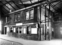 Given the interest in the current rebuilding of Glasgow Queen Street here is<br>
a BR PR&PO view of part of the station prior to a previous rebuilding.<br><br>
<br><br>
The caption simply reads 'No 2 Booking Office : Queen Street'. The<br>
photograph was taken on 23rd November 1955.<br><br>
<br><br>
The board to the right of the building reads:<br><br>
<br><br>
No 15 Window<br><br>
Airdrie, Milngavie, City and District Stations, Weekly Season Tickets and<br>
Railway Employee Privilege Tickets<br><br>
<br><br>
A destination between Airdrie and Milngavie has been painted out. We think it may be Bothwell (closed a little earlier in the year - July 1955) - does anyone know better?<br><br>
<br><br>
A handwritten note on the back states 'Must return Day Features' so possibly<br>
suggests the photo was lent out for a press feature.<br><br>
<br><br>
 Top left hand corner '2/8' suggests this is one of eight of a series of<br>
views. I only have one and two!<br><br>
<br><br>
We think this may be the former Dundas Street entrance. This had an indoor taxi rank (left) and several arches. To orientate yourself, today the entry to the low level platforms is to the right.<br>
<br><br>[PR&PO British Railways (Douglas Blades Collection) 23/11/1955]
