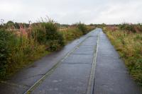 This was one of the lines serving the Nobel Explosives site at Ardeer. It was concreted over to provide road (and retain rail) access to the site from the north east, thus preserving the line.<br>
<br>
The branch originally served Misk Colliery No1, Bogend Pit and a chlorine works.<br>
<br>
The branch closed when severed by the A78 dual carriageway. Track on this section was, not surprisingly, left in place. This is the view east to Stobbs Junction with the A78 on the left.<br><br>[Ewan Crawford 07/09/2017]