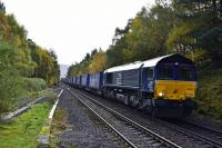 66424 ascends the gradient from Findhorn Viaduct and enters the loop at the closed station of Tomatin on 12th October 2017 with a full load of curtainside containers heading for Inverness.<br>
<br>
<br><br>[John Gray 12/10/2017]