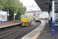 The Leaf Train on route to Airdrie passing a Milngavie service at Coatbridge Sunnyside.<br><br>[Alastair McLellan 23/10/2017]