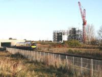 The Edinburgh and Midlothian Recycling and Energy Recovery Centre, under construction in the south west corner of Millerhill Yard, towers above the passing ScotRail 0911 Edinburgh - Tweedbank on 12 November 2017. The train is about to make its scheduled stop at Shawfair station, just off picture to the right.<br><br>[John Furnevel 12/11/2017]