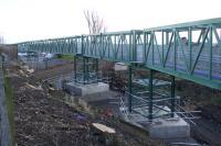 View north east of part of the temporary pedestrian and services bridge which has been erected alongside the A905 Kerse Road overbridge. Revised plans have now been approved for the work as part of the preparation for electrification. <br>
<br>
<br>
<br><br>[Colin McDonald 31/12/2017]