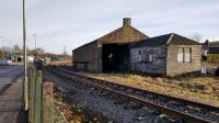 The GNSR goods shed at Keith still stands. In the foreground is the Dufftown platform line, the buffer on this line being not far behind the camera. The main Aberdeen-Inverness line is off to the left.<br><br>[David Prescott 30/01/2018]