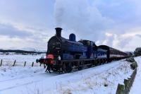 The Strathspey Railway's Santa Express, hauled by Caledonian Railway 0-6-0 No.828, runs towards Broomhill on 11th December 2017. Part of the snow covered Cairngorms can be seen in the background and, yes, it was as cold as it looks!.<br>
<br><br>[John Gray 11/12/2017]